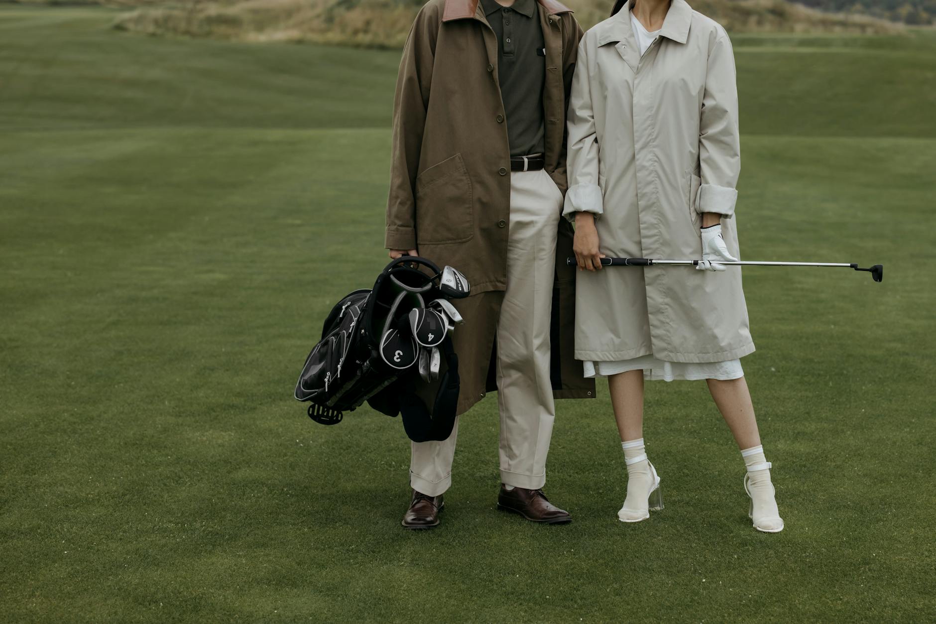 Couple walking a golf course together on a clear afternoon