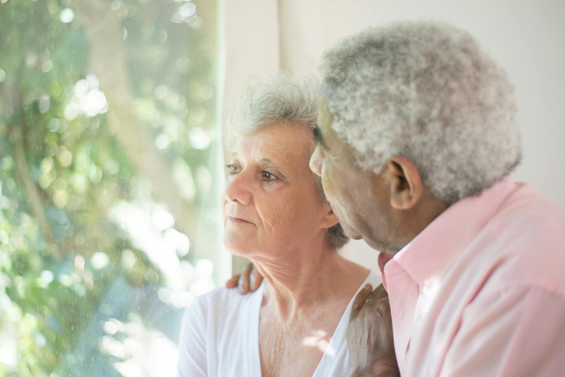 Elderly woman on phone discussing insurance options with agent