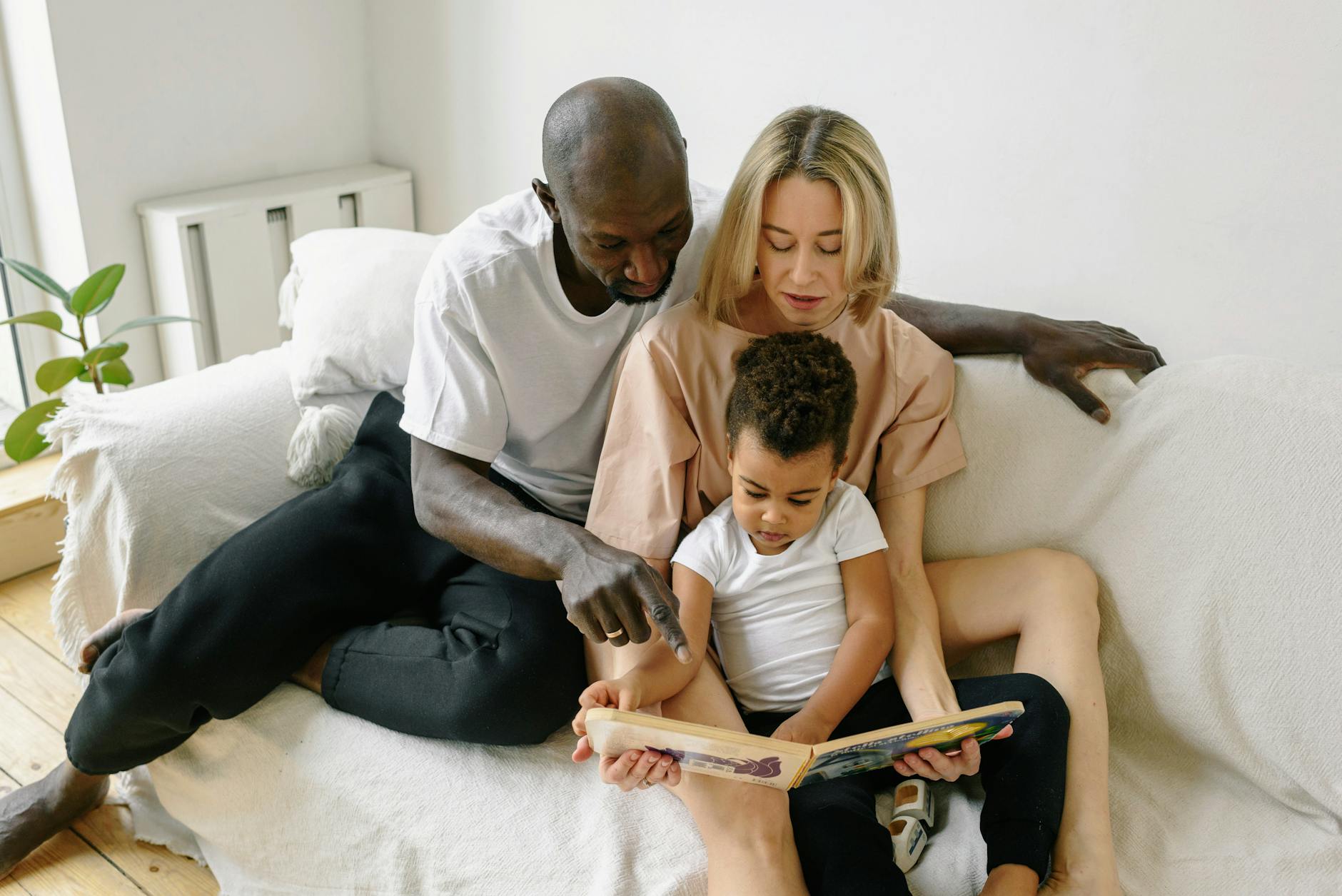 A family reviewing insurance documents at their kitchen table, highlighting the importance of protecting purchasing power